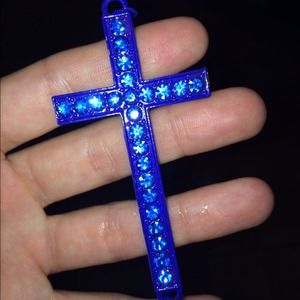 A royal blue cross necklace with blue crystals