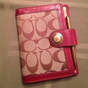 Coach day planner and pen.