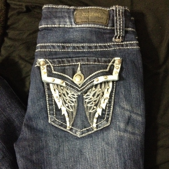 Dark wash jeans with angel pattern on pocket