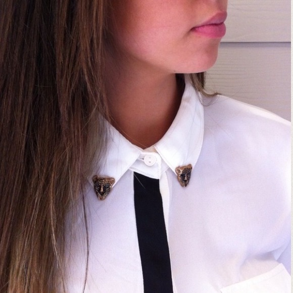 White button up top with small gold tiger detail.