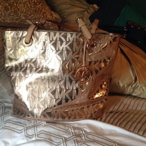 Rose gold Michael Kors bag with gold accents