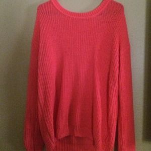 Neon coral cable knit sweater.
