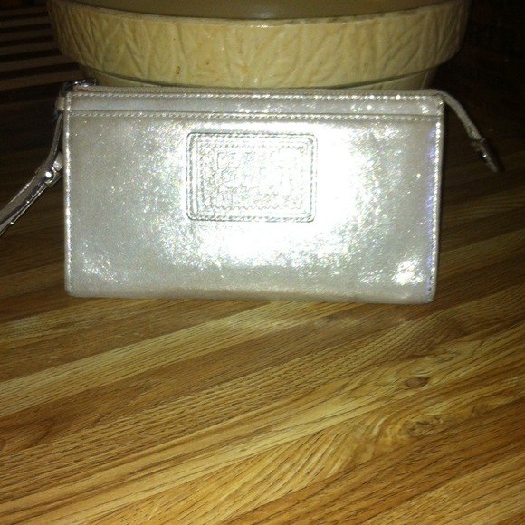 Coach poppy wristlet gold in color