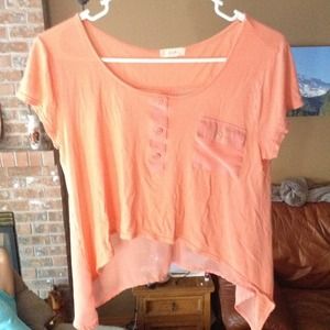 Pink-orange shirt. See through in the back.