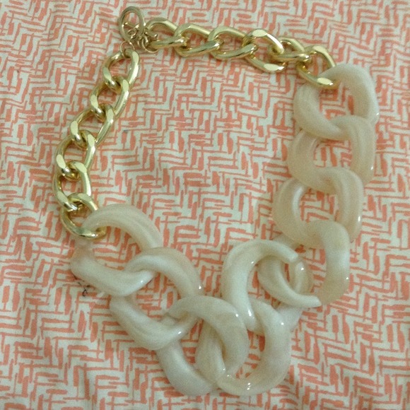 White and gold chain necklace.