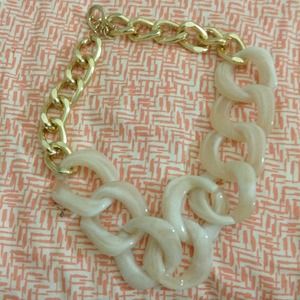 White and gold chain necklace.