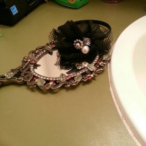A black headband with rhinestones