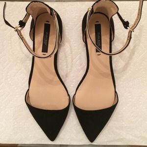Zara black point flats with gold straps.