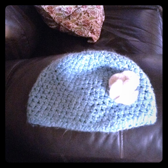 knitted baby blue hat with white flower
