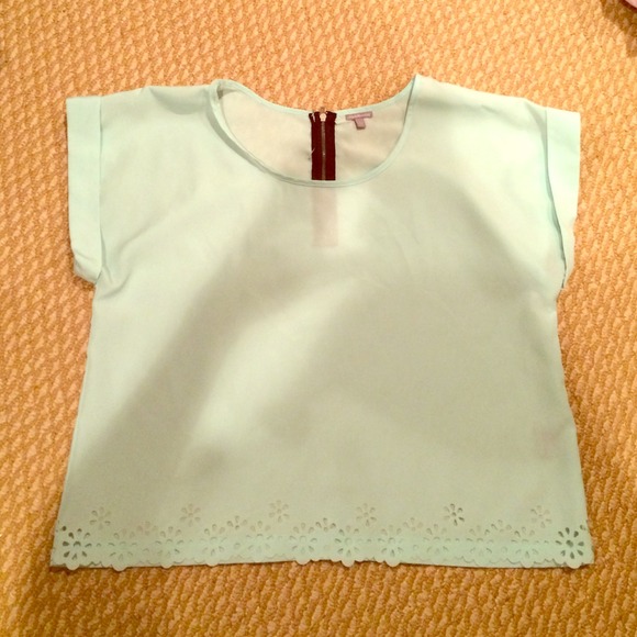 Powder blue boxy top with eyelet details.