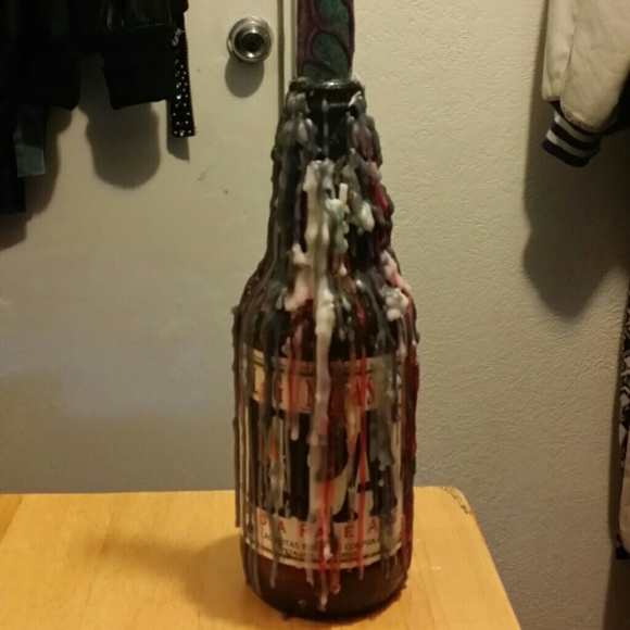 Decorative candle that drips on two bottles