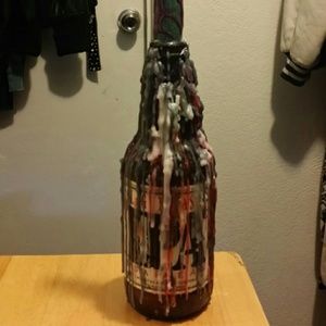 Decorative candle that drips on two bottles