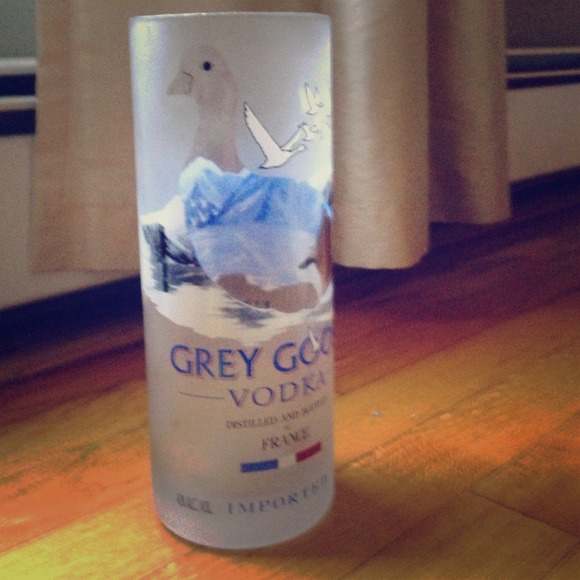 A hand cut vase made from recycled liquor bottle