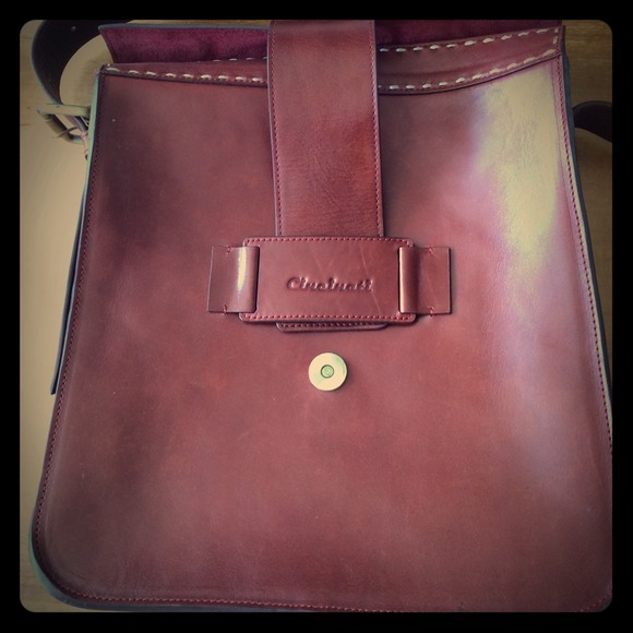 Tan leather bag with white stitching