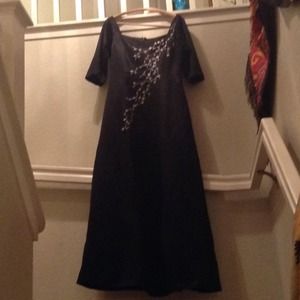 A black dress w/ silver & white flower embroidery.