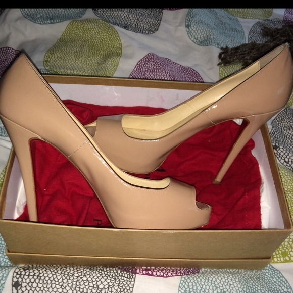 Christian Louboutin peep toe platform pumps.