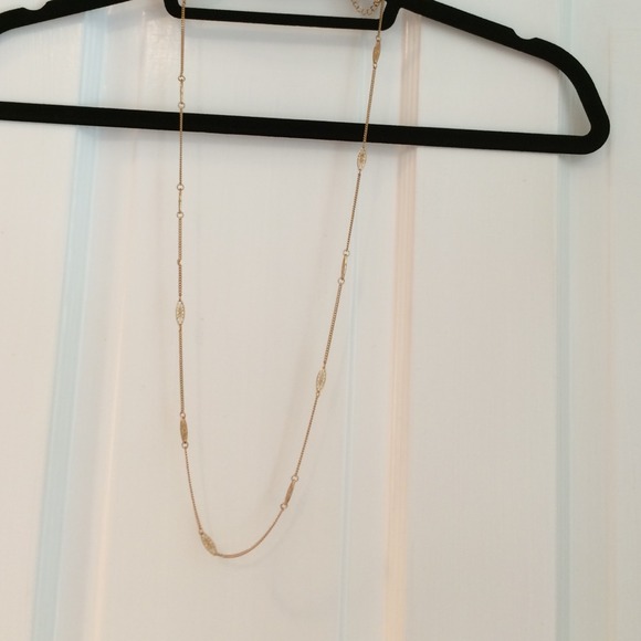 Gold necklace with small charms in chain