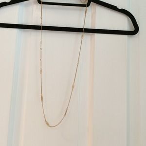 Gold necklace with small charms in chain