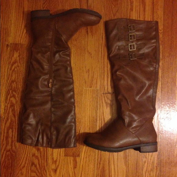 Brown over-the-knee riding boots.