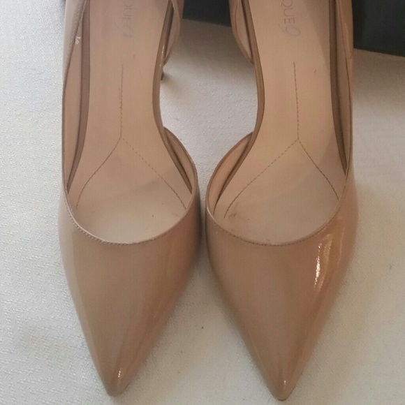 Nude patent leather pumps.