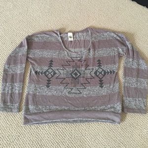 Long sleeve brown striped top with tribal design.