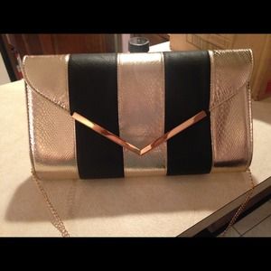 Golden and black snake pattern purse.
