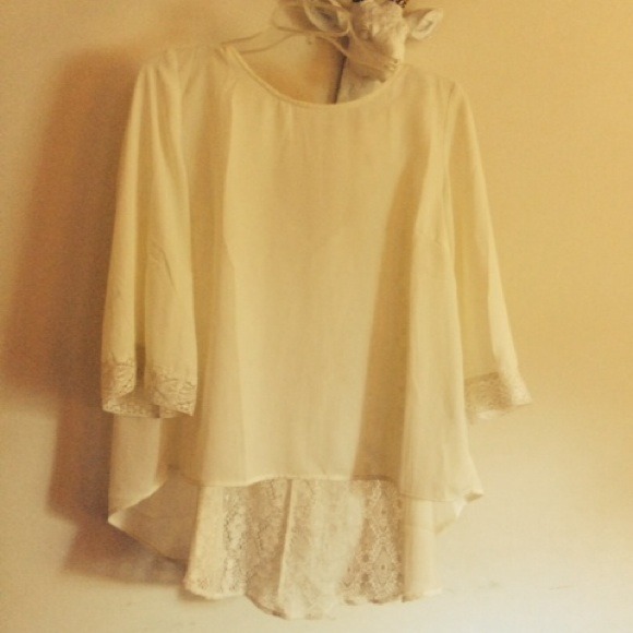 Off white blouse with lace detailing.