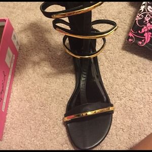 Black with gold accent gladiator flats.