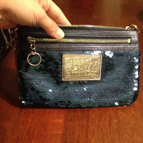 Metallic blue coach clutch.