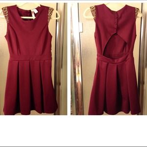 Burgundy dress with gold studded shoulders.