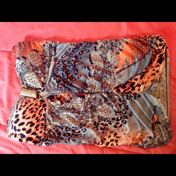 Strapless with gem in the middle of bra part.