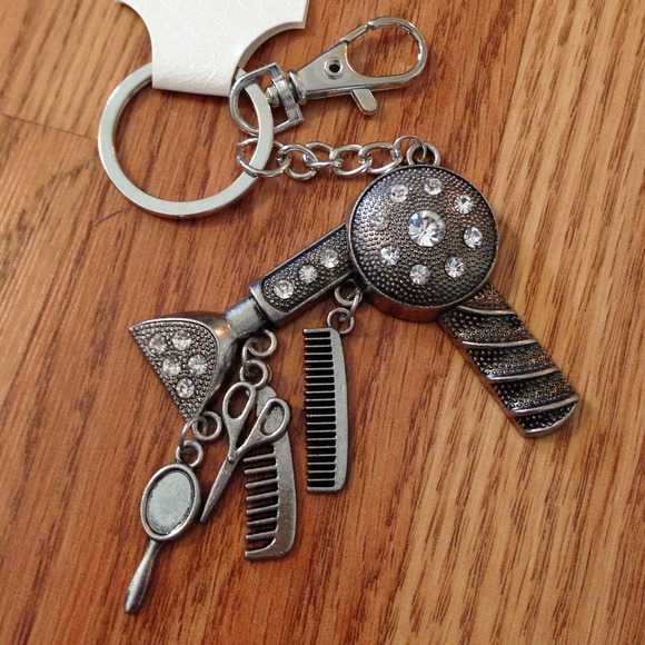 Silver color beautician themed keychain.