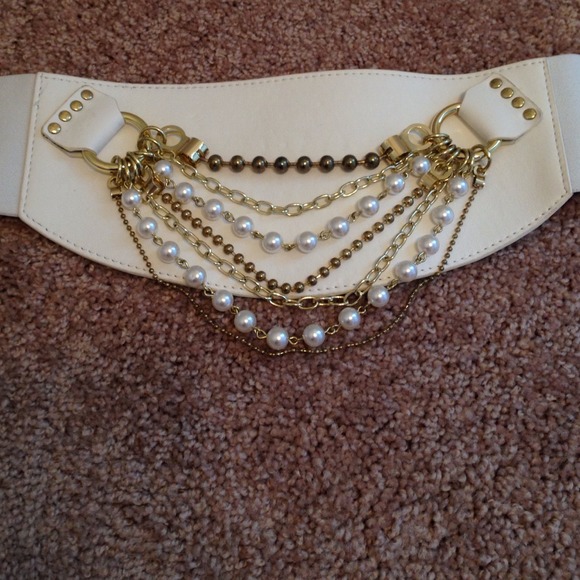 Wht BEBE belt with gold chains and pearls.