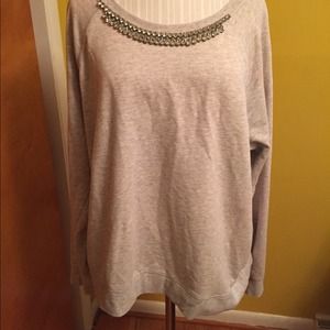 Embellished gray sweatshirt and cobalt peplum top.