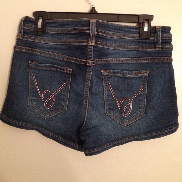 Dark denim BEBE shorts with gold B's on the back
