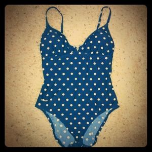 Navy blue and white polka dot one-piece swimsuit