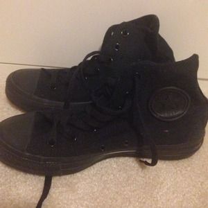 Black high top converse with leather seal.