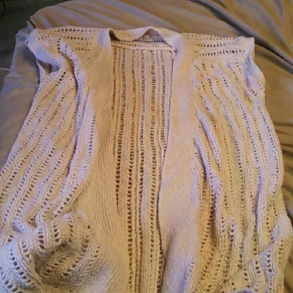 Knit short sweater over top