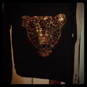 Black sweater with sequined lion in the front