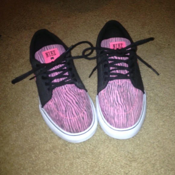 Zebra striped and black Nike shoes