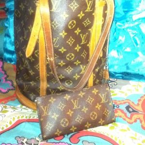 Louis Vuitton bucket bag and attached wallet.