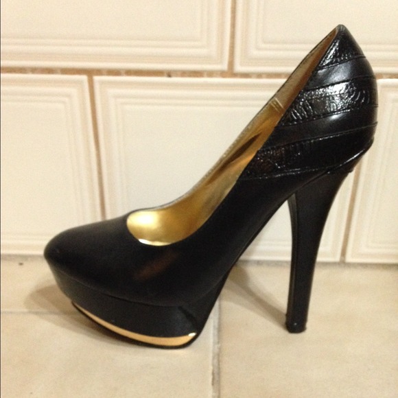 Michael Antonio. Black and gold platforms.