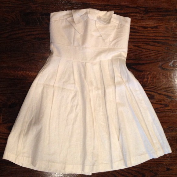 Tags on. Light cream colored dress with bow