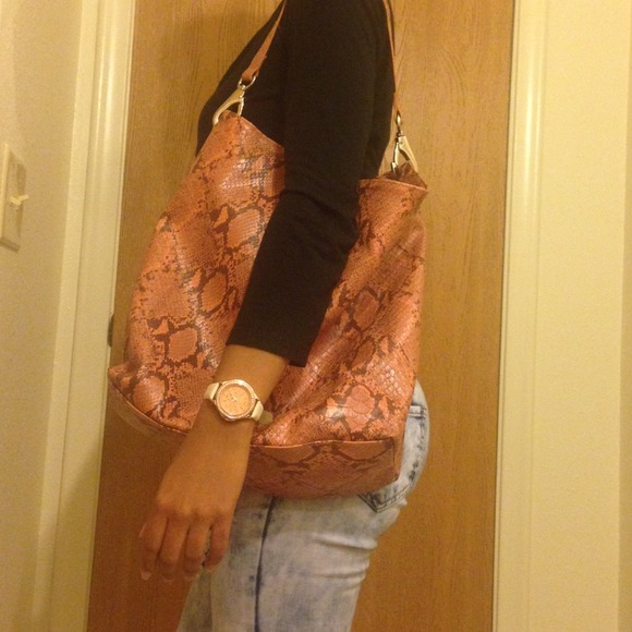 Orange colored faux snakeskin tote