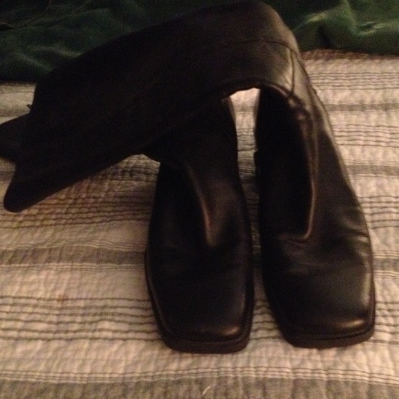 Black knee hi leather boots.