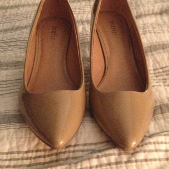 Nude patent leather kitten heels.