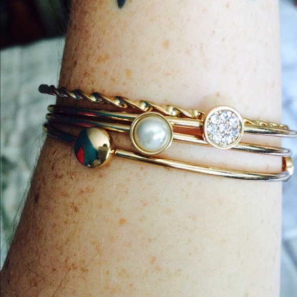 Dainty gold bangles.
