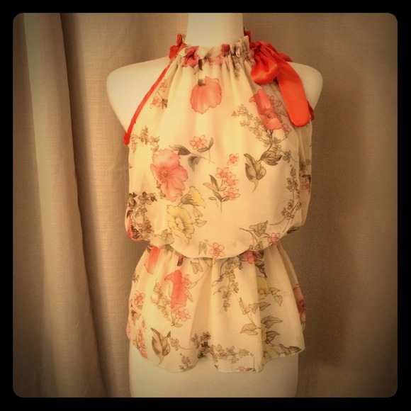 Sheer cream blouse with orange trim.