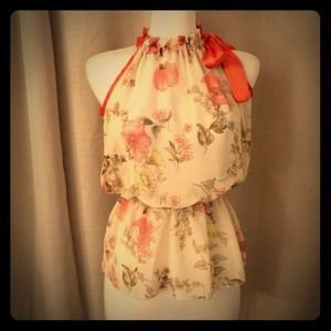 Sheer cream blouse with orange trim.