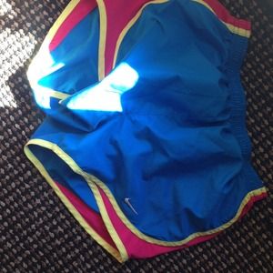 Blue and yellow nike running shorts